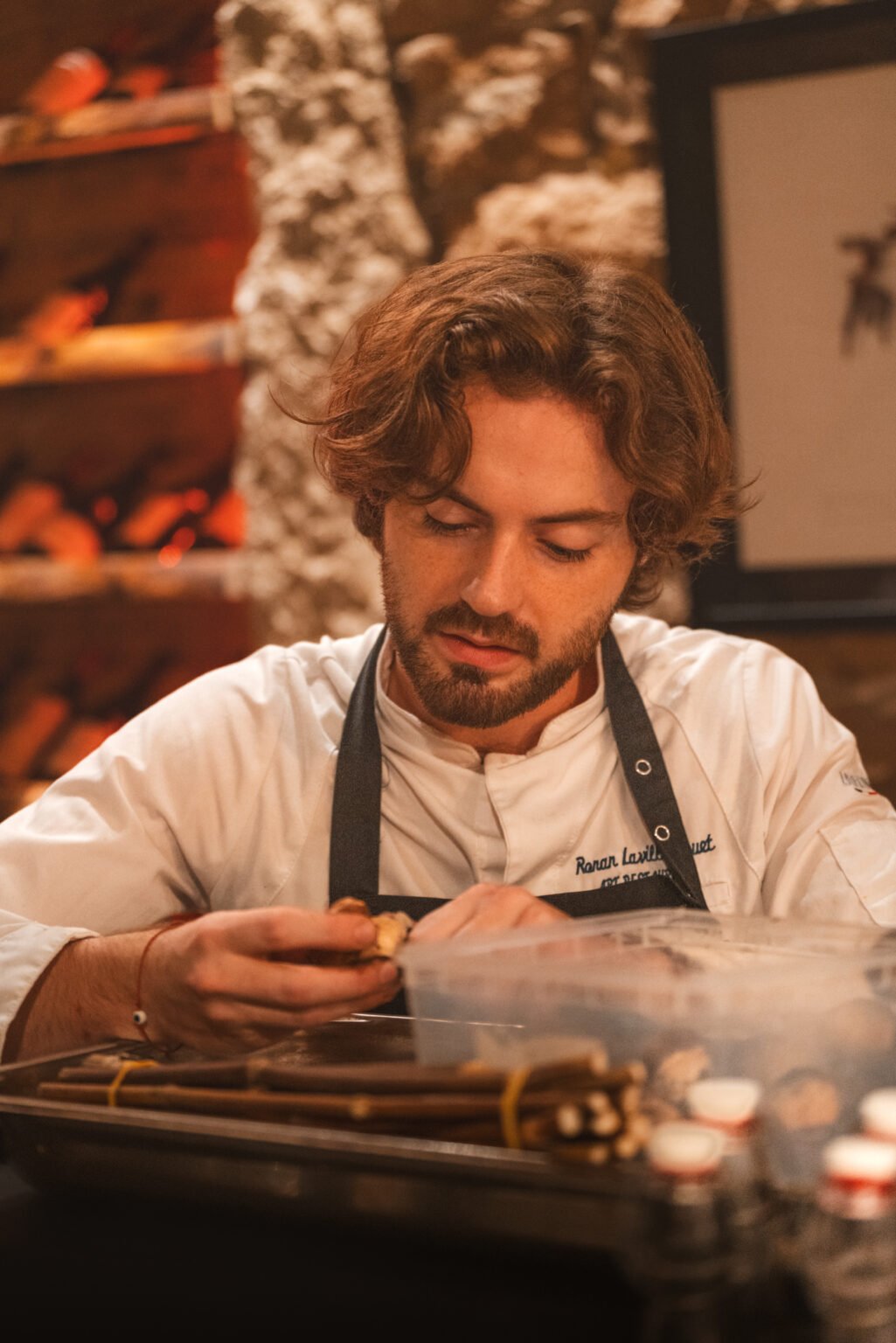 Le chef Ronan Lavillaugouet dresse une assiette dans la cuisine d'ART